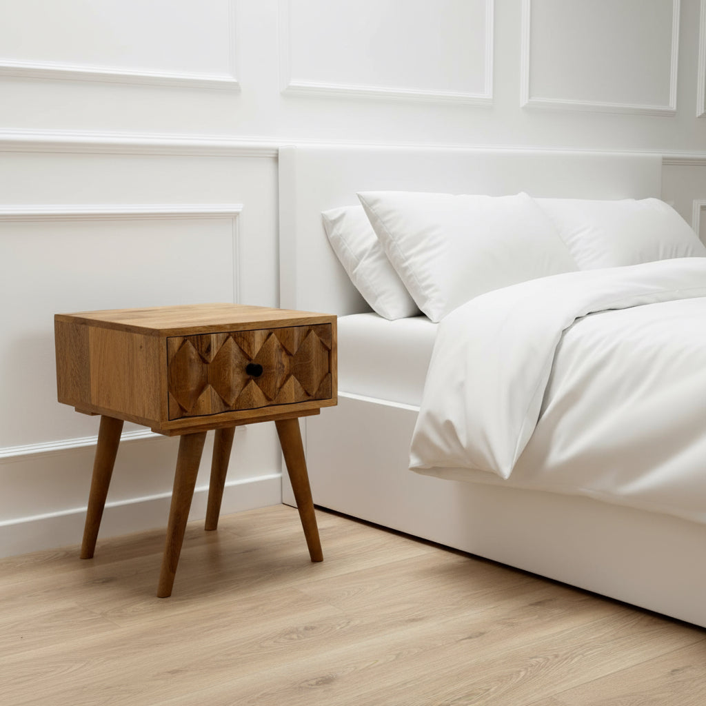 Wooden side table with a single drawer on a wooden floor.