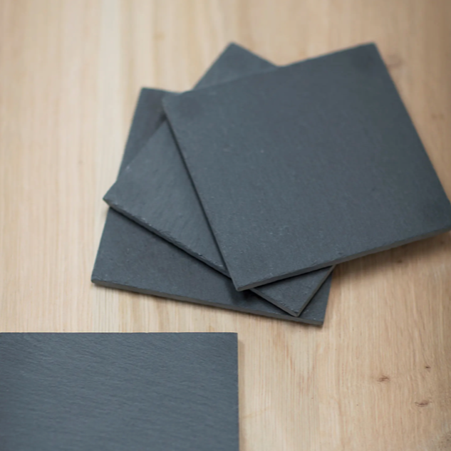Set of 4 Slate coasters. Stacked on top of each other.