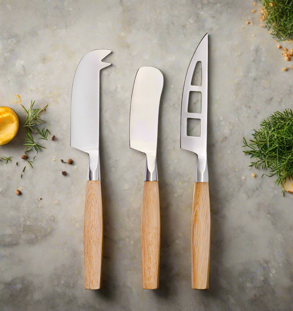 3 cheese knives on a marble worktop