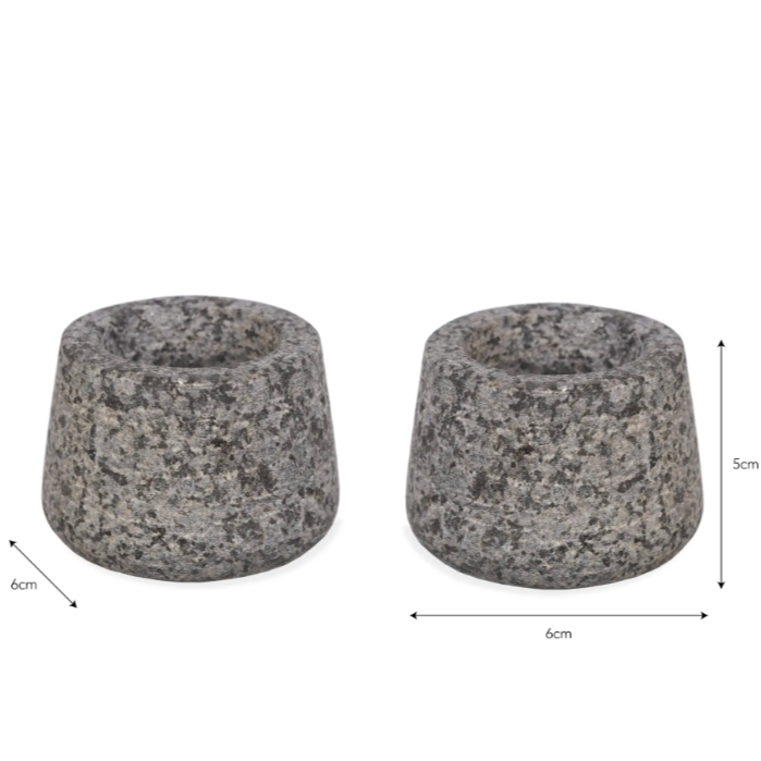 Two grey stone candle holders with dimensions on a white background