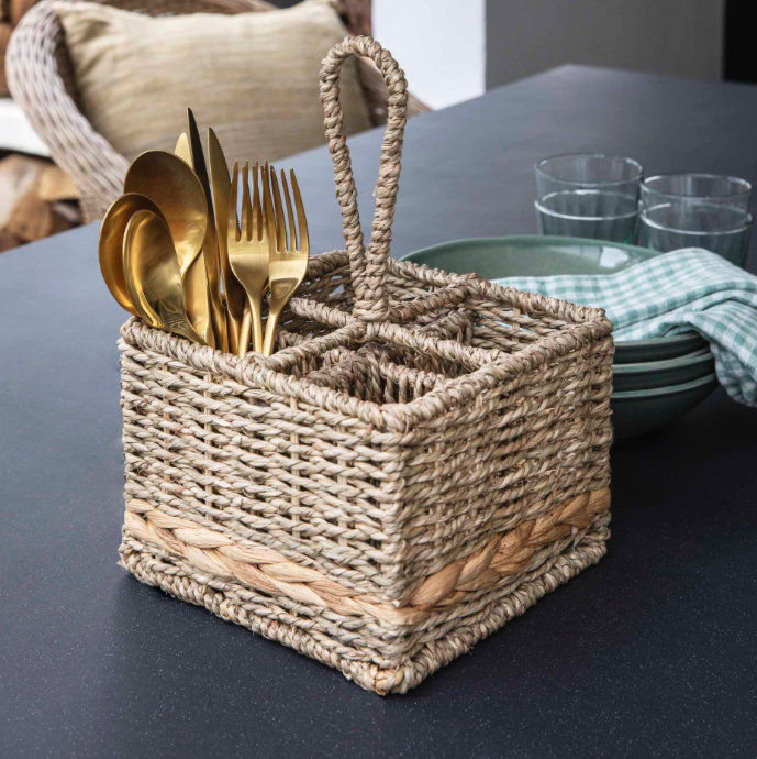 Woven seagrass and water hyacinth condiment caddy with cutlery in it