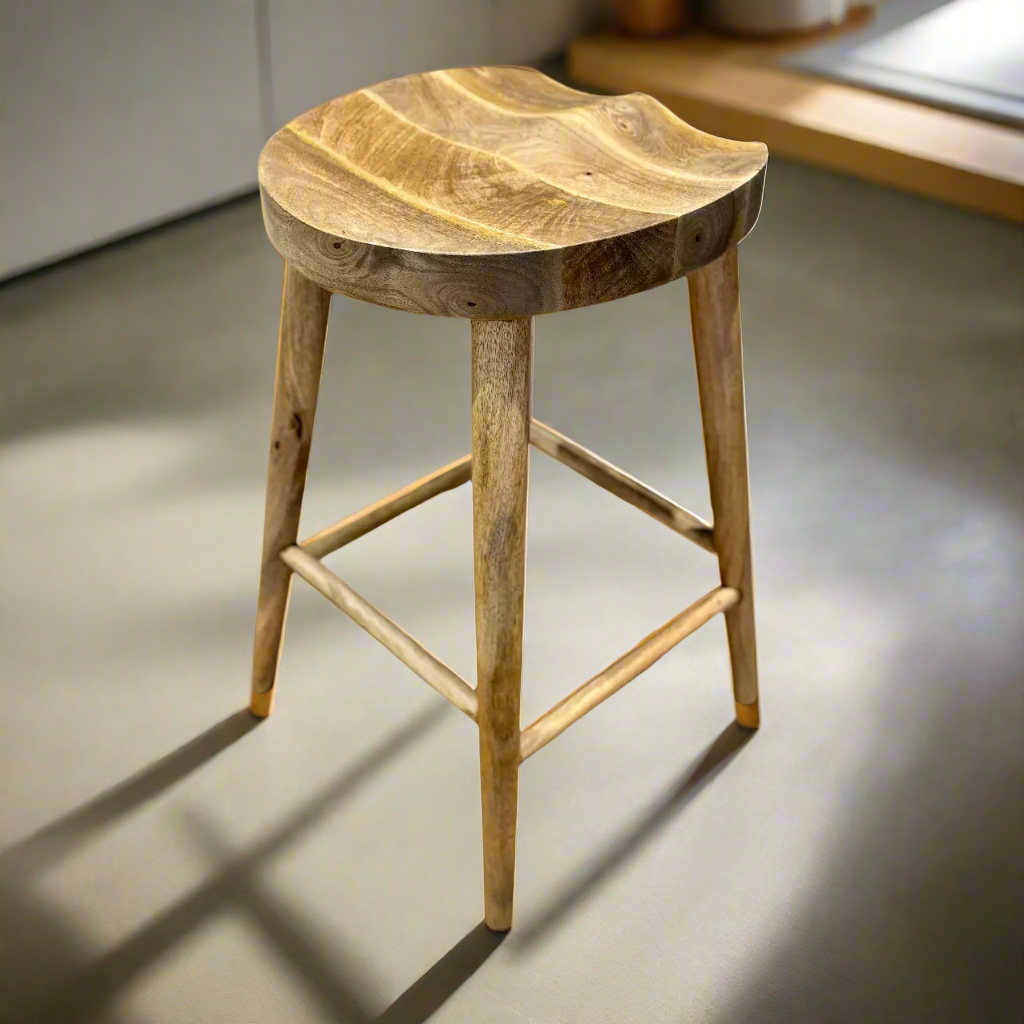 Mango wood bar stool with scalloped seat on a clean floor