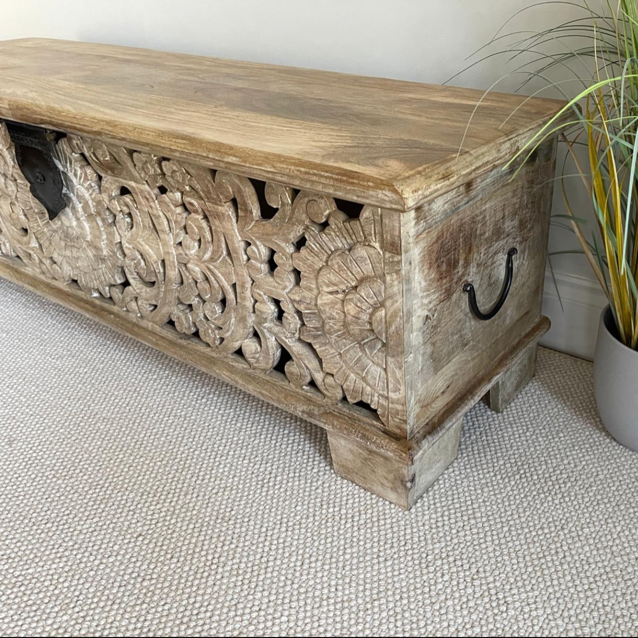 White washed with etched front long blanket style chest looking from the corner
