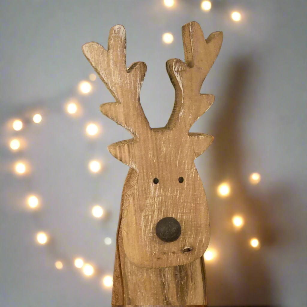 Floor standing reindeer decoration - wood with metal detail. Close up of face.