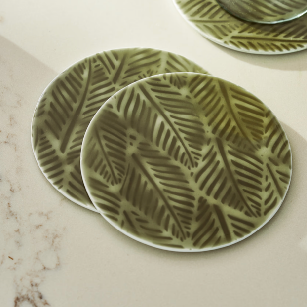 Set of 4 metal coasters - close up.