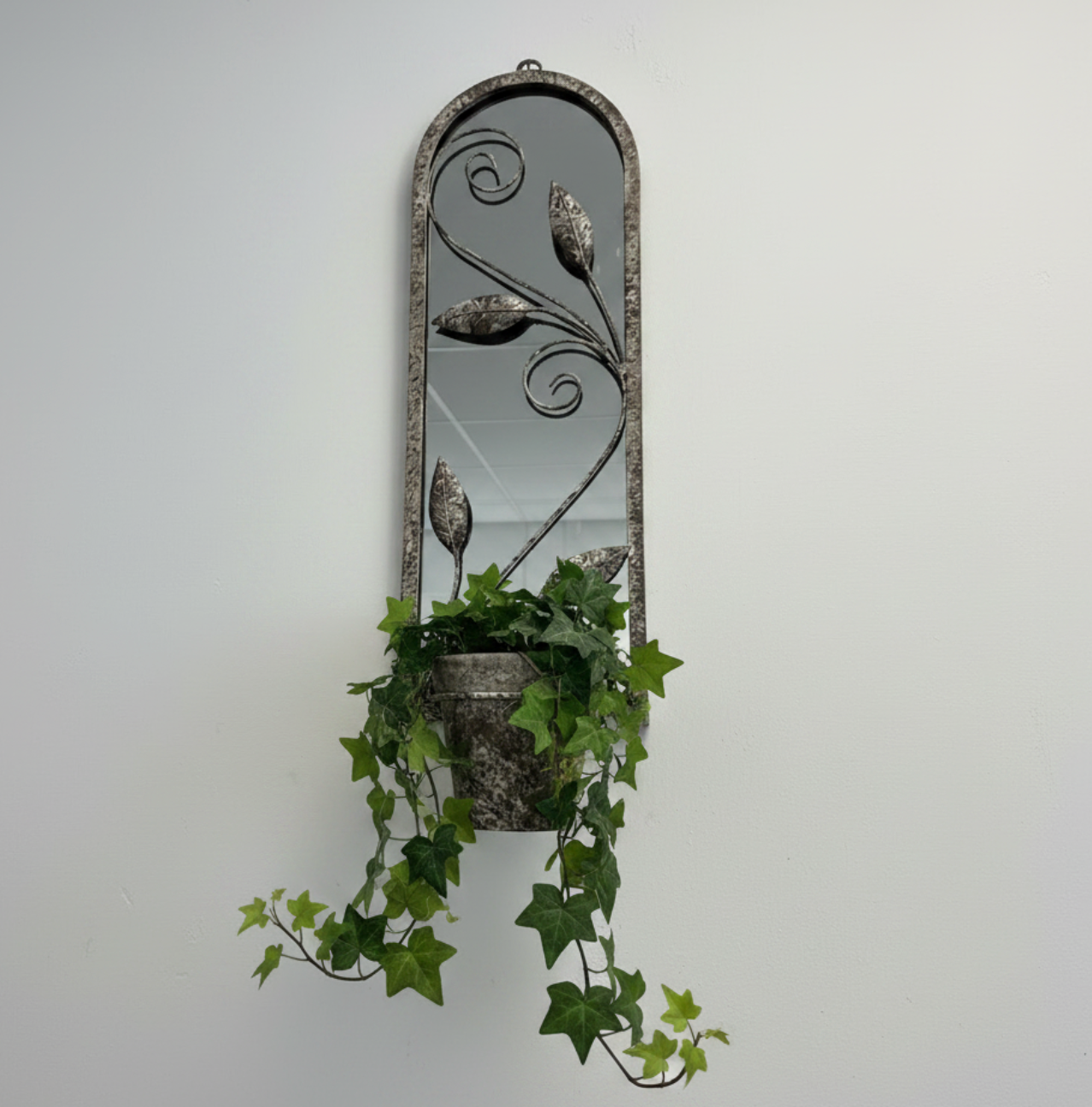 Arched leaf mirror with a plant pot