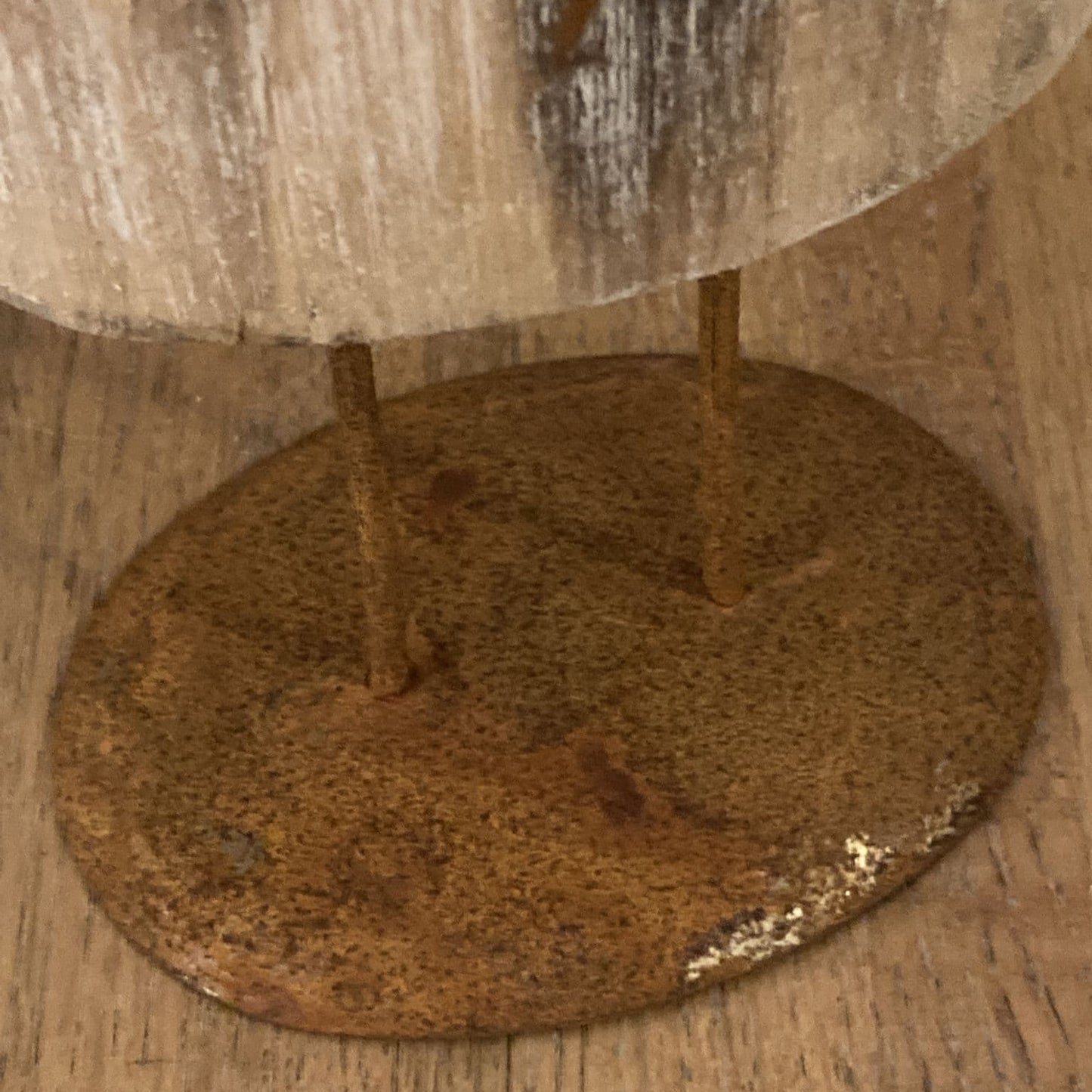 Floor standing reindeer decoration - wood with metal detail - close up of base.