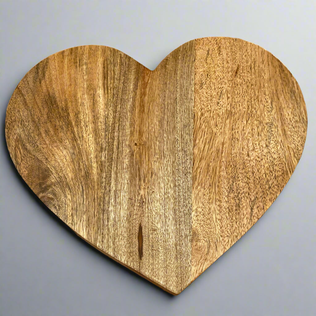 Large heart shaped Mango wood chopping board. Handle optional. Front view.