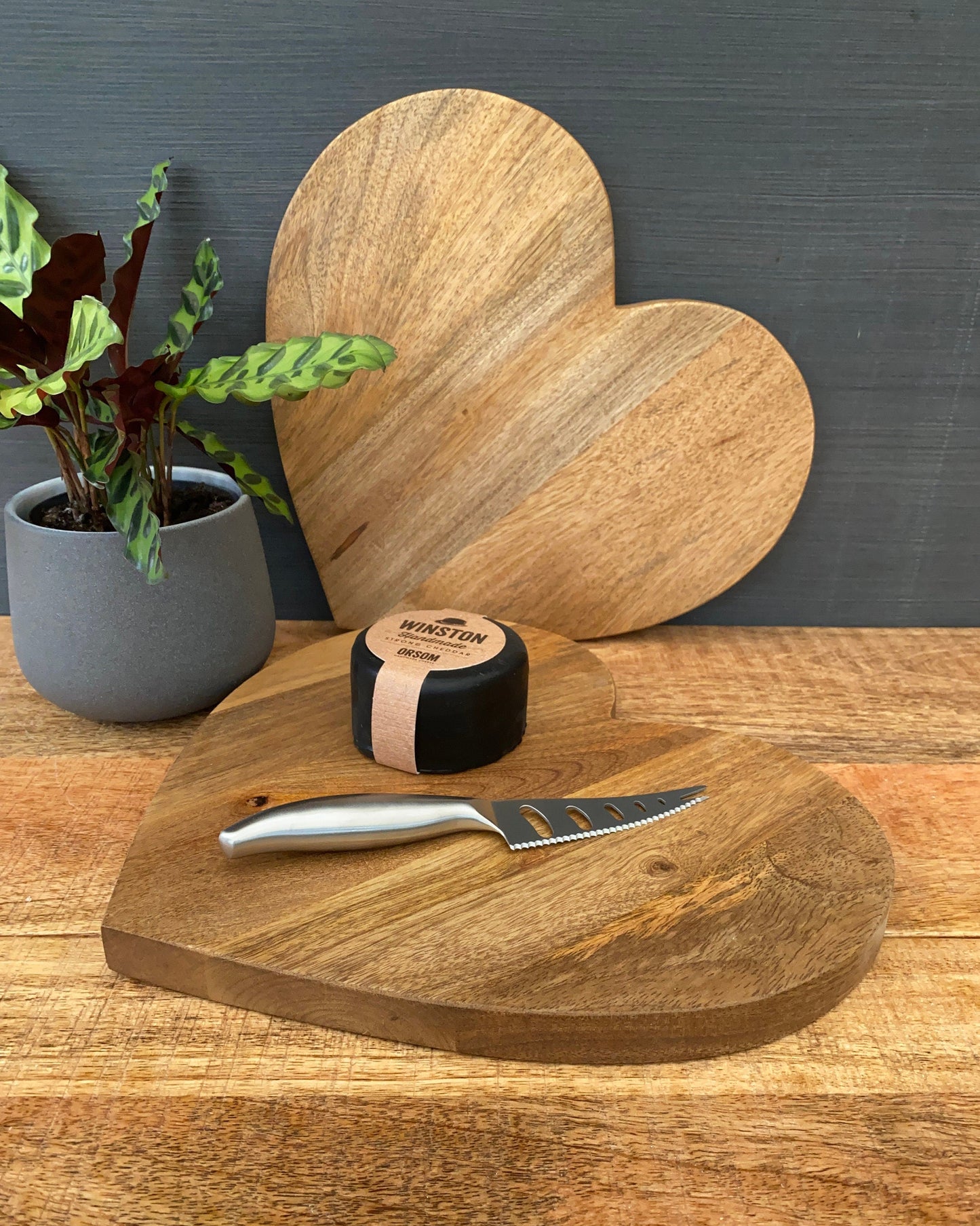 Large heart shaped Mango wood chopping board. Handle optional. Board with cheese and knife.