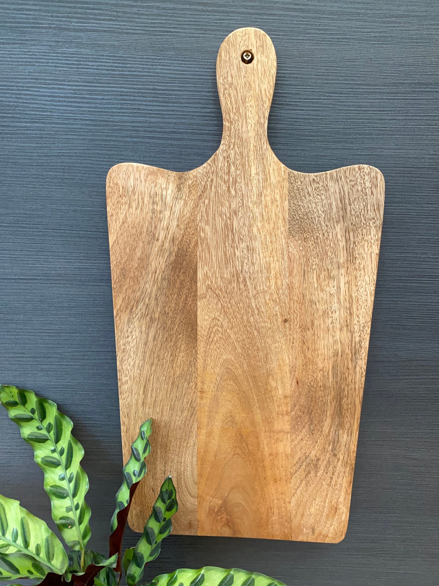 Solid Mango wood food serving paddle boards - Available in 3 sizes. Board hanging on wall for easy storage.