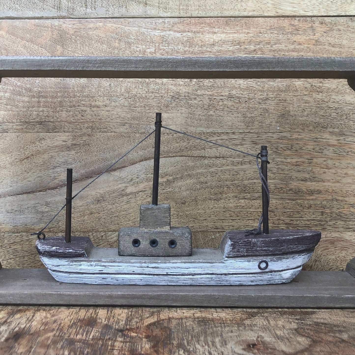 Rustic wood framed boat - shelf sitting decoration. Front view.