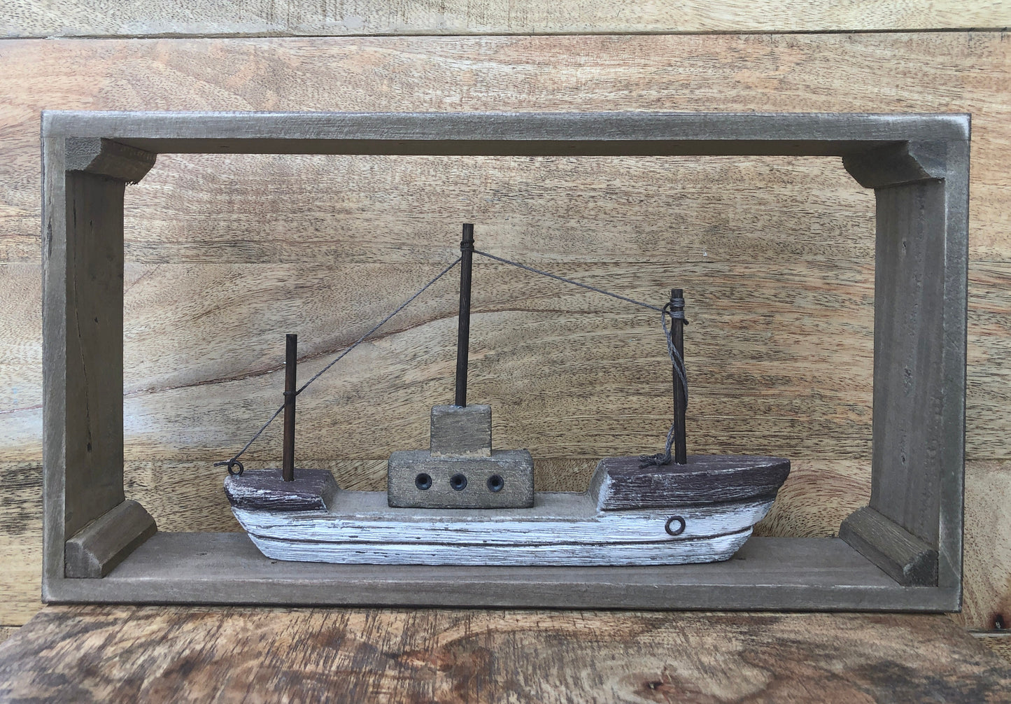 Rustic wood framed boat - shelf sitting decoration. Full Frame.