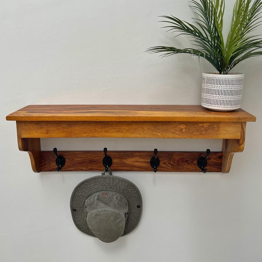Sheesham wood 4 hook hat and coat rack with shelf. Front on with hat and plant.