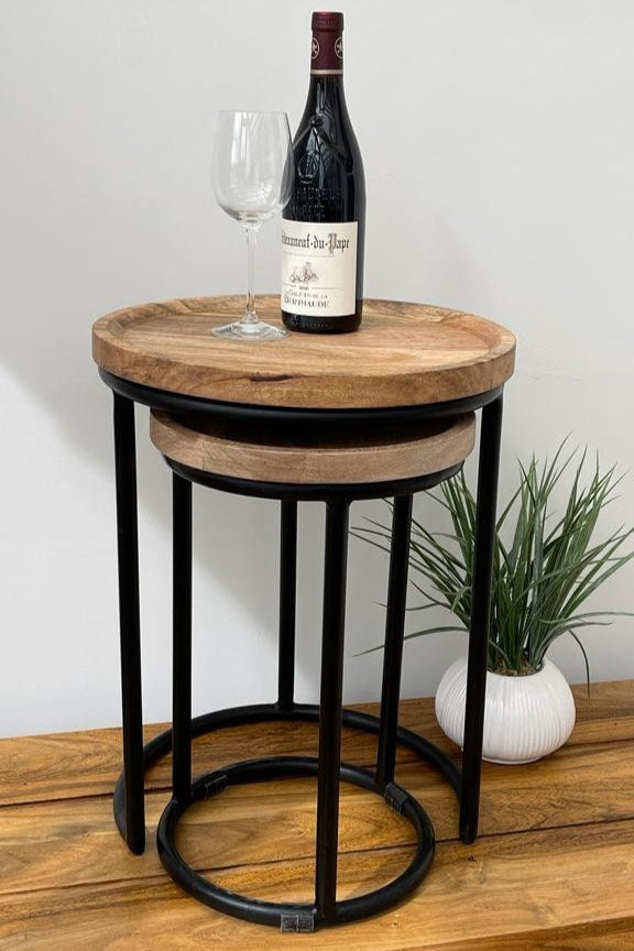 Nest of 2 Industrial style slim round side tables. Bottle and wine placed on top.