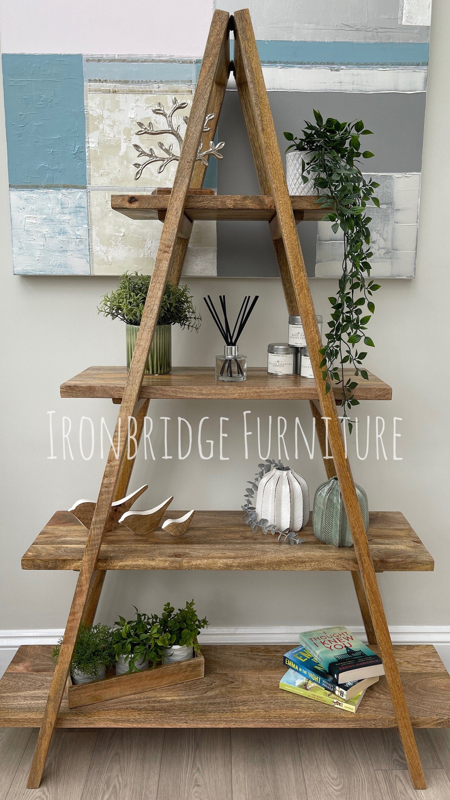 A-frame folding Mango wood 5 part bookcase with items on. Straight on shot.