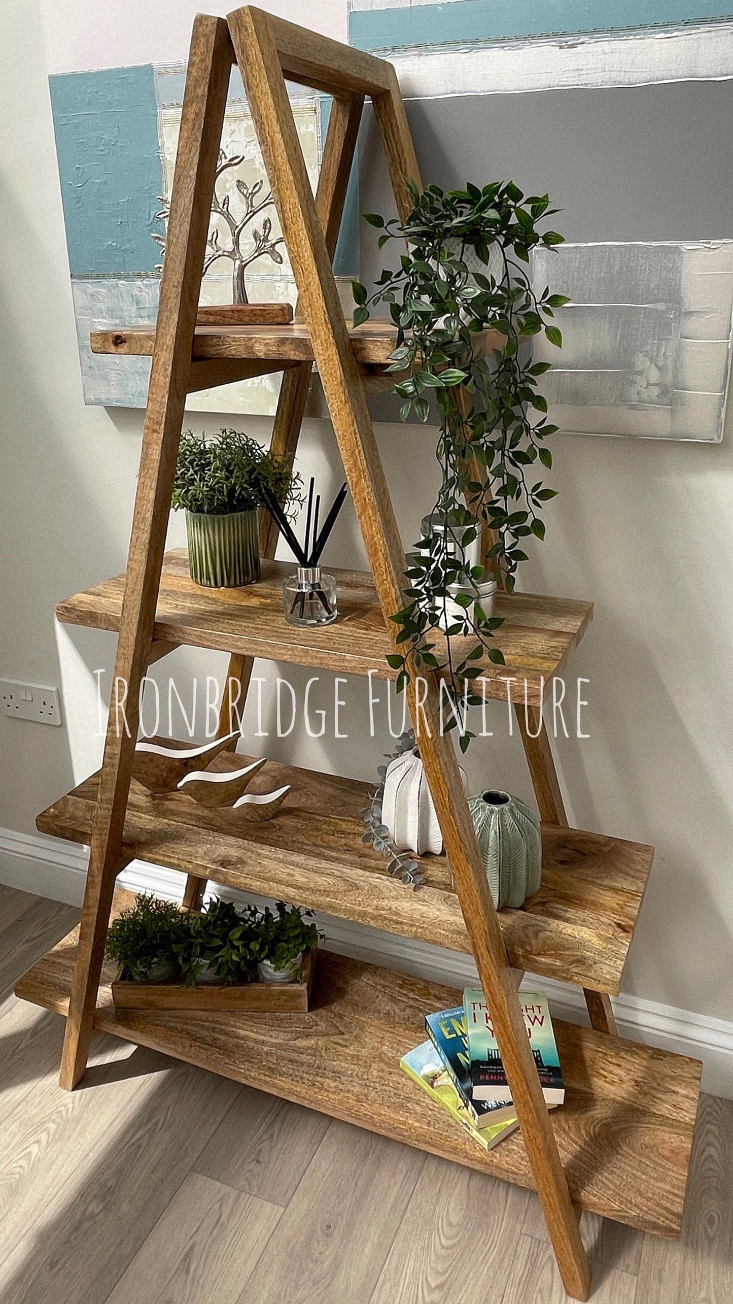 A-frame folding Mango wood 5 part bookcase with items on. Side-on shot.