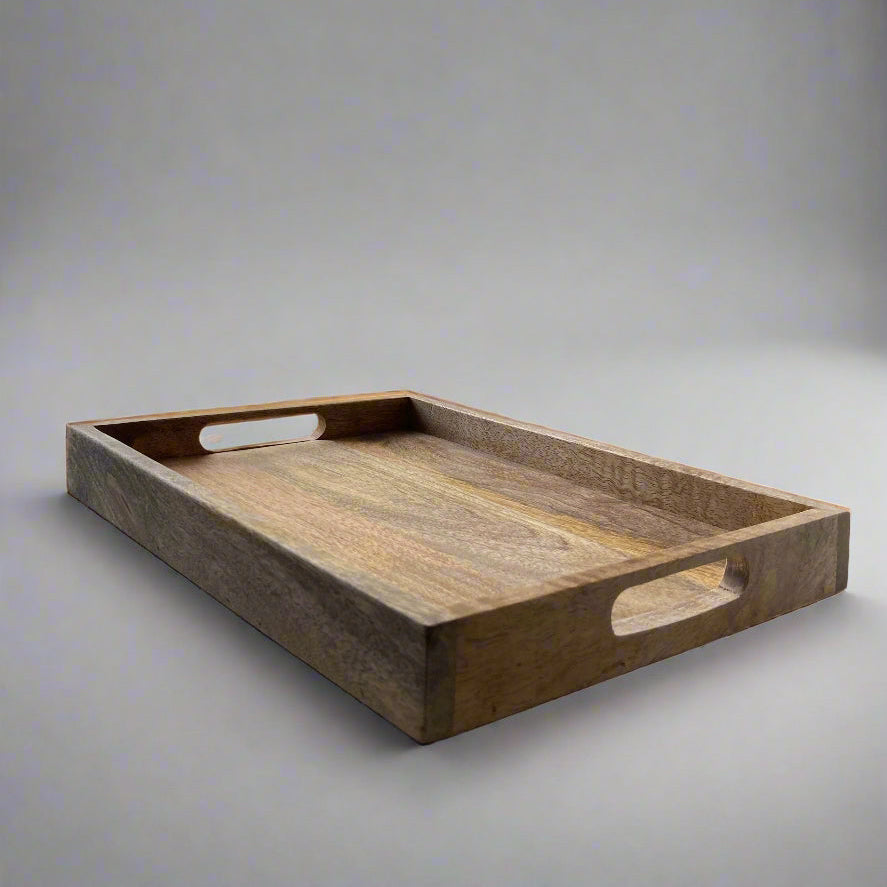 Mango wood straight edge tray with cut out handles. 35x25x4cm on a plain background