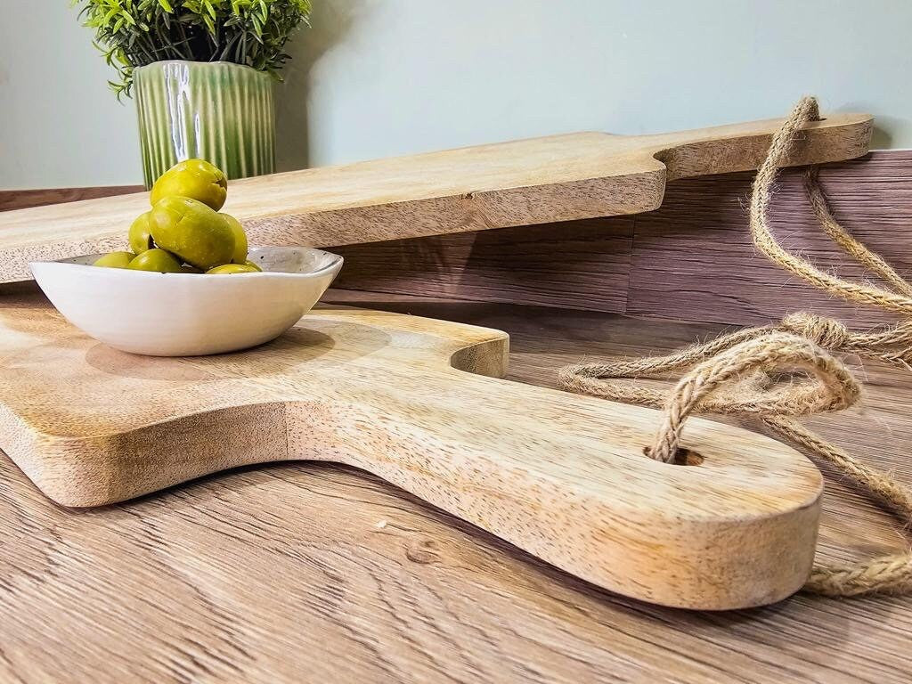 Long slim Mango wood paddle grazing boards close up