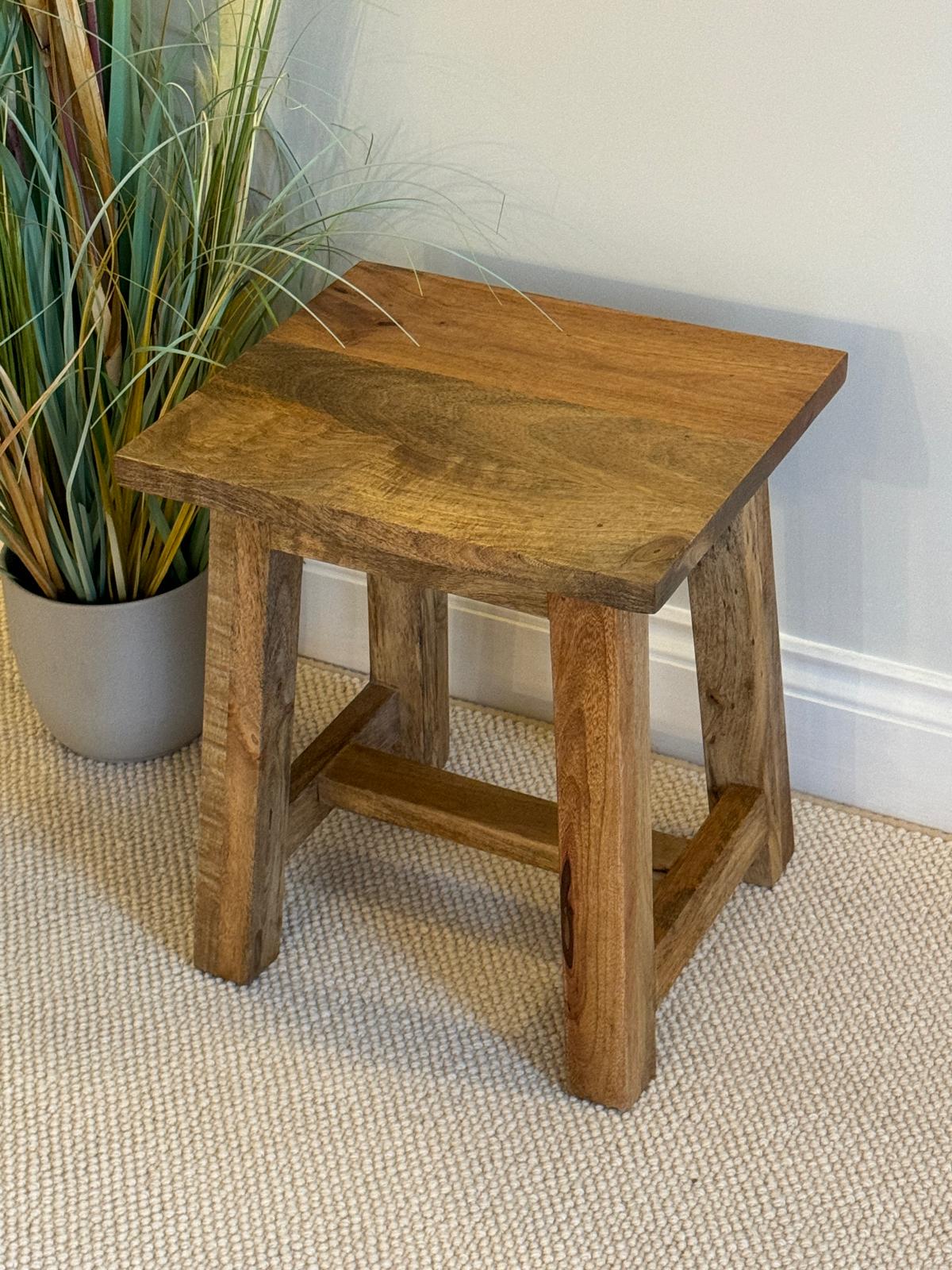 Mango wood stool or occasional side table at an angle