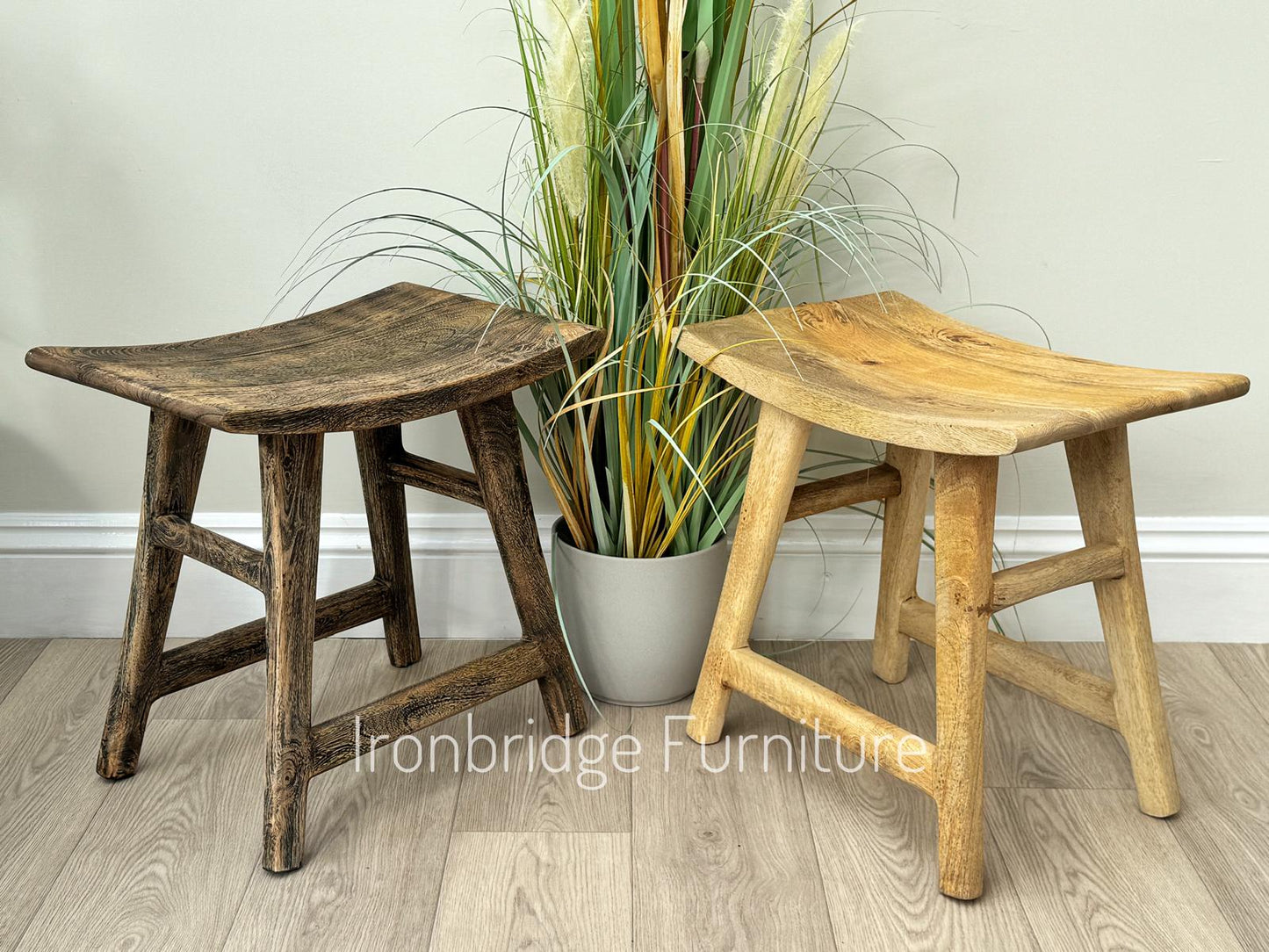 Curved rustic Mango wood stool. Two stools placed side by side.