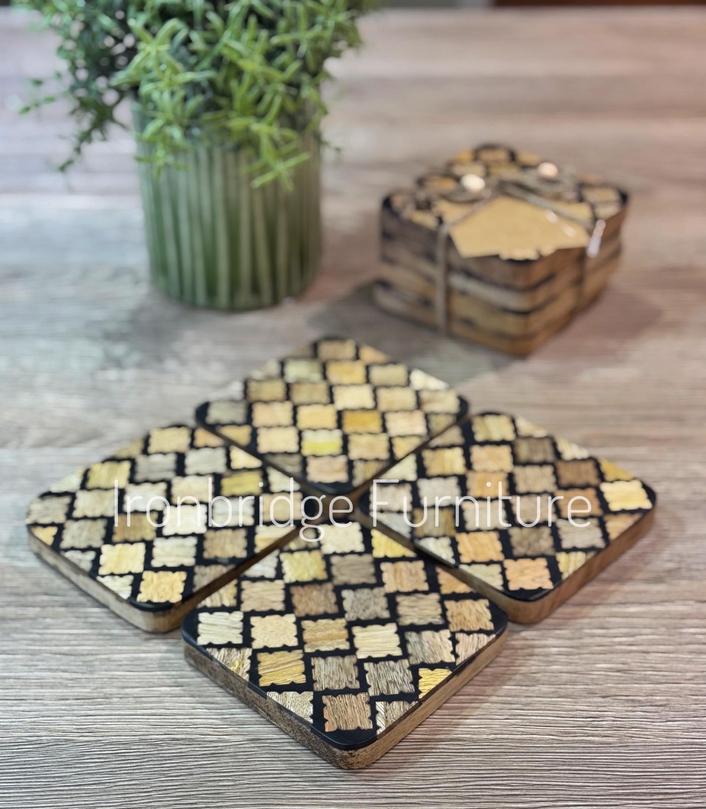 Set of 4 resin coasters with Mango wood inlay and base. On table.