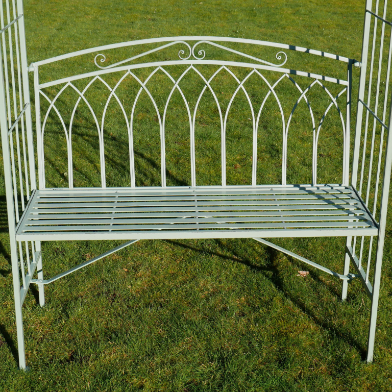 White metal garden bench on a grassy background
