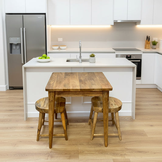 Wooden dining table with four stools on a wooden floor.