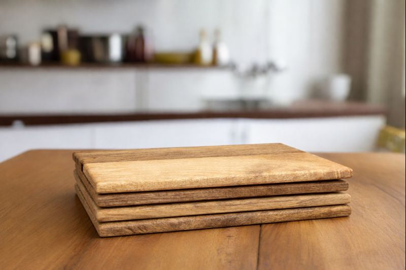 Set of rounded edged solid Mango wood placemats and coasters
