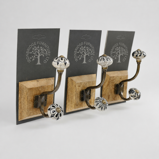 Two wooden wall hooks with decorative metal knobs on a white background, featuring ironbridge Furniture Ltd branding.