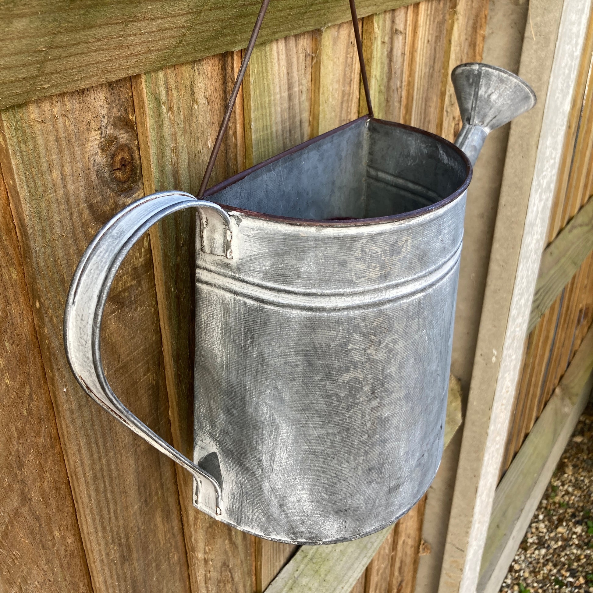 Zinc wall hanging watering can planter - side angle. 