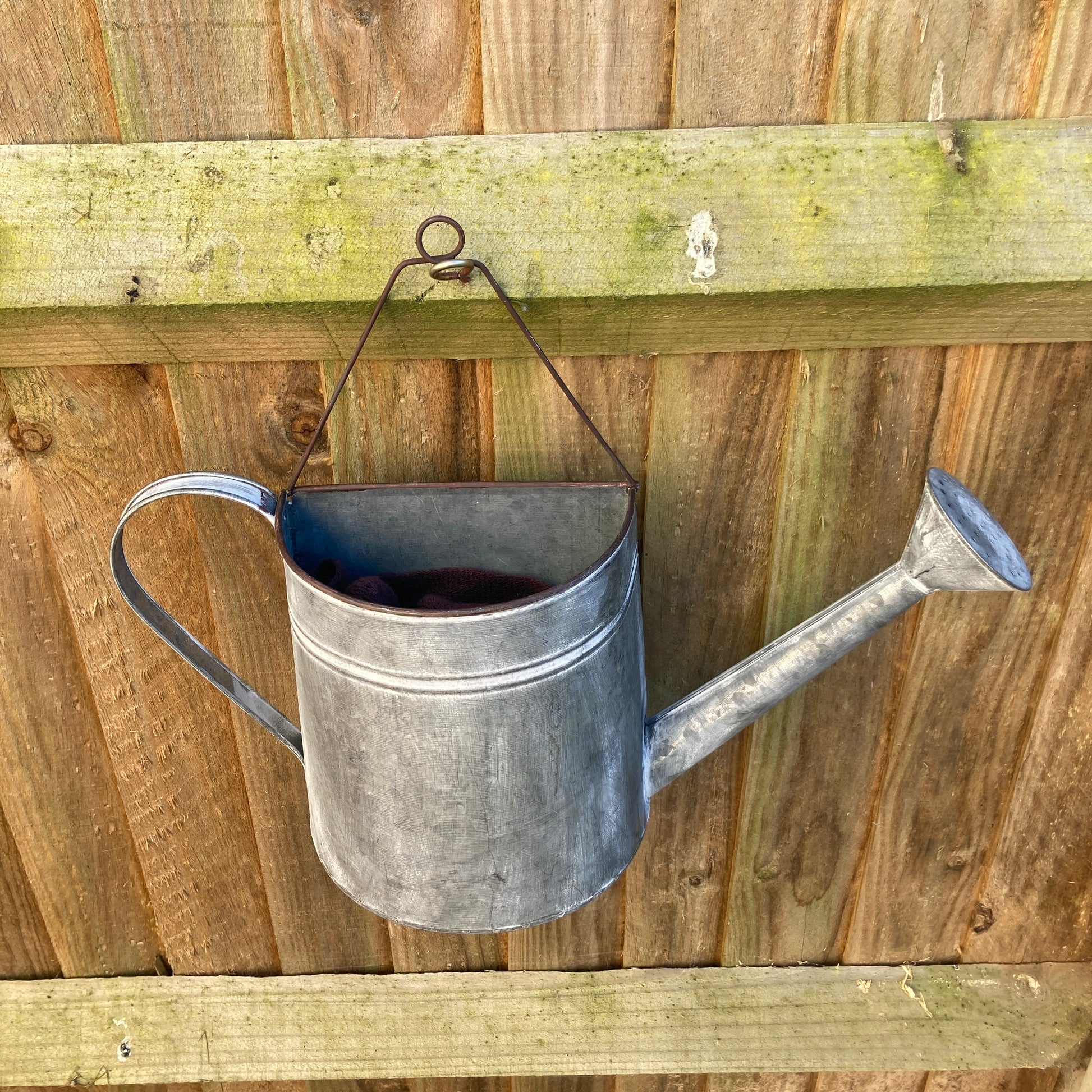 Zinc wall hanging watering can planter - from above.