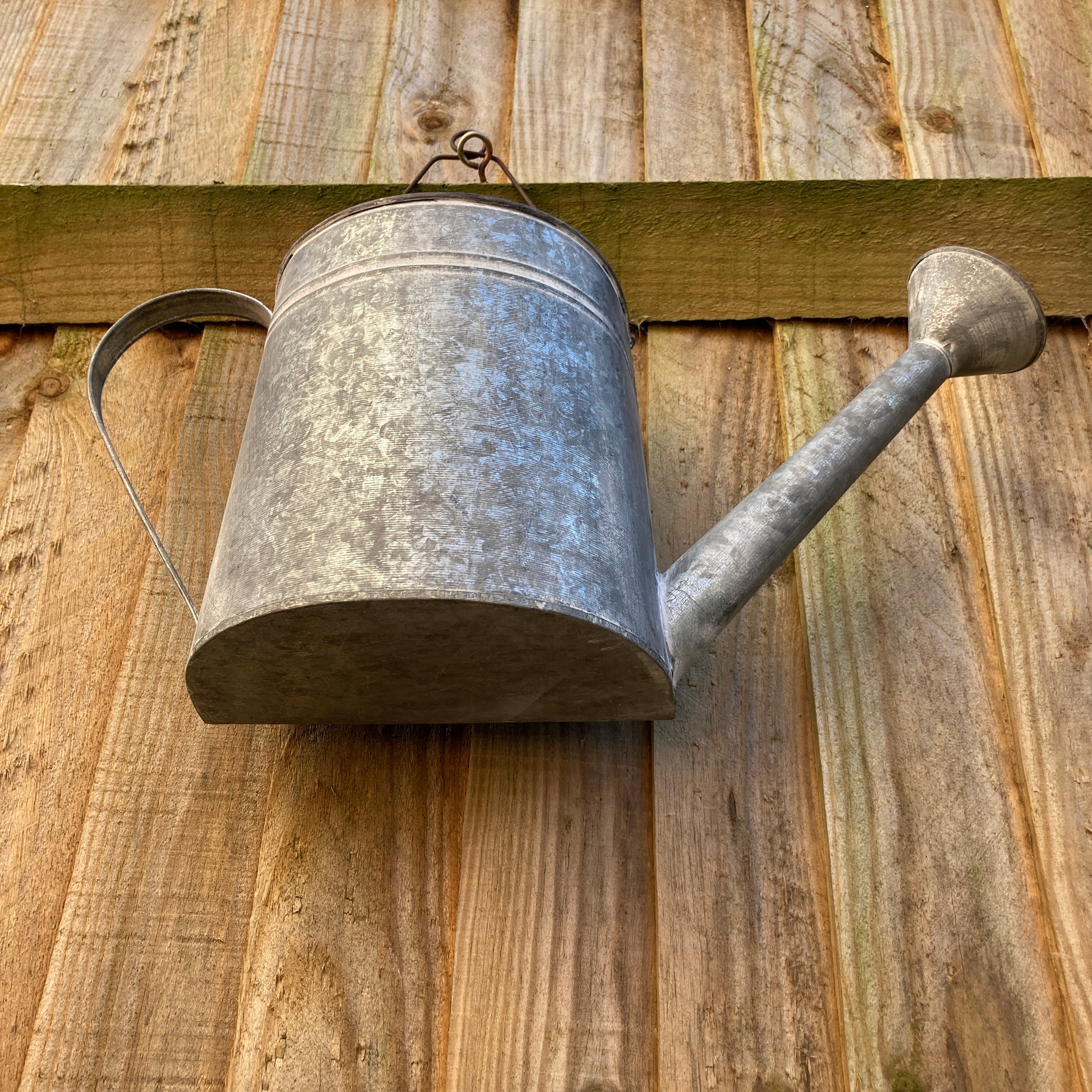 Zinc wall hanging watering can planter - from beneath.