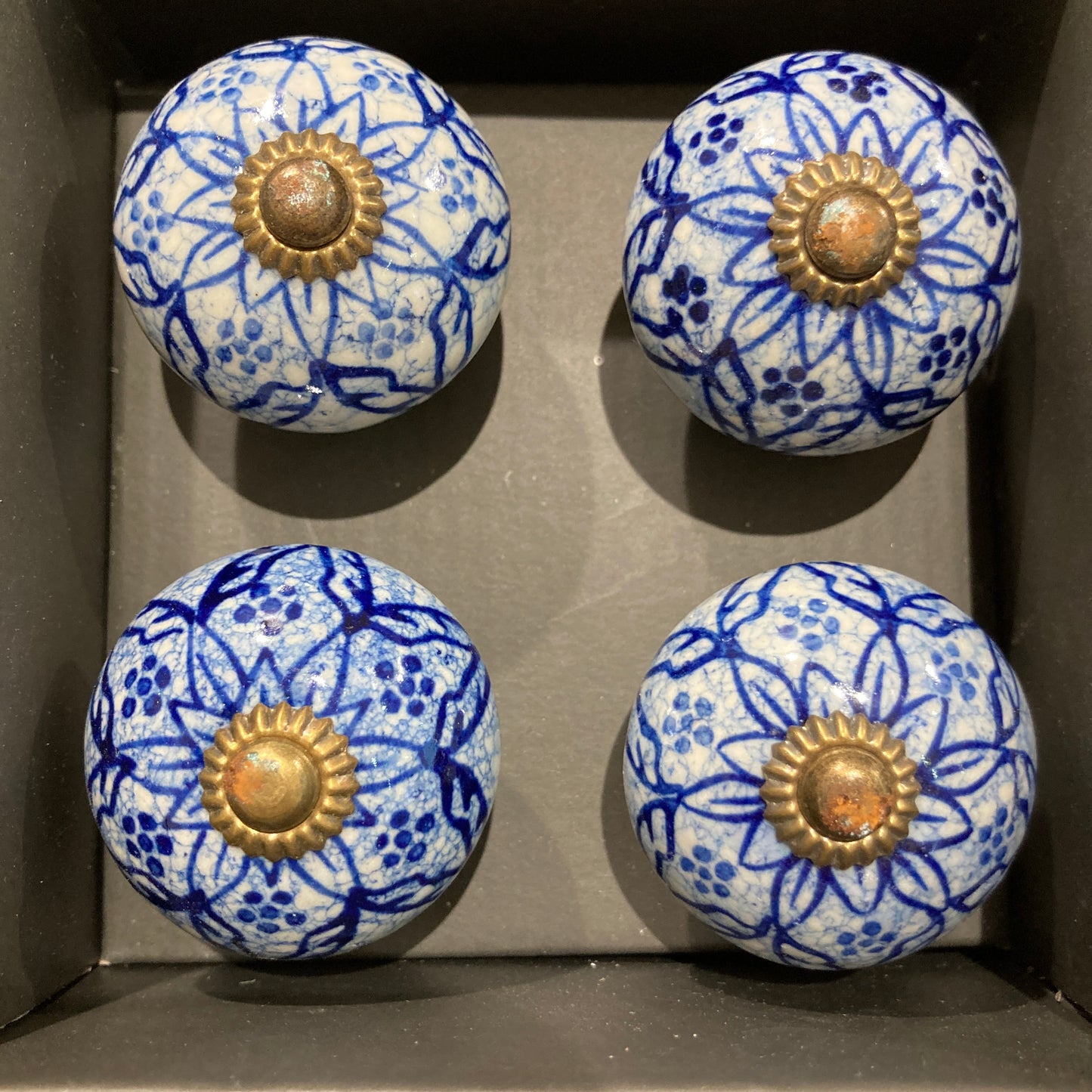 Set of 4 hand painted ceramic knob handles. Patterned in box.