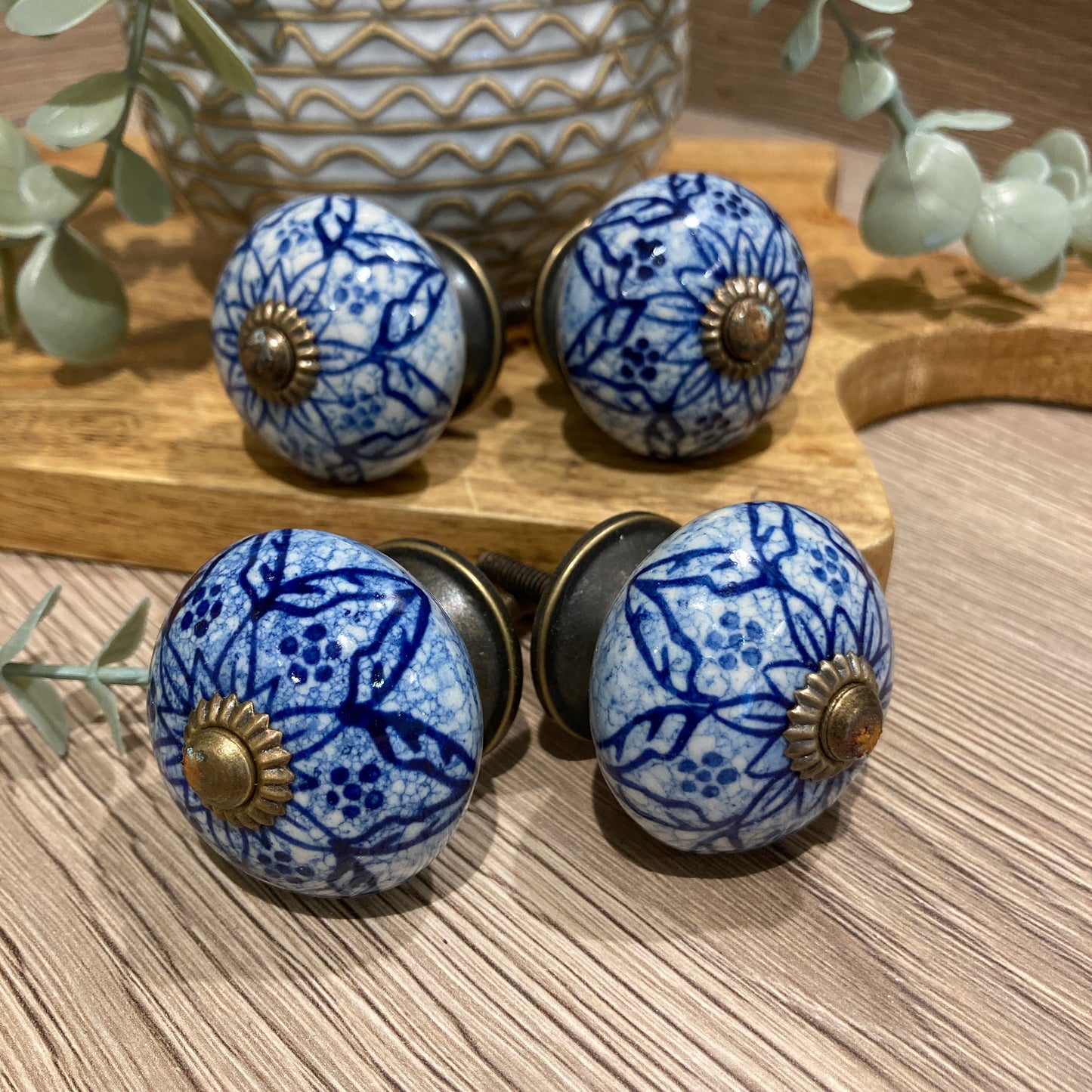 Set of 4 hand painted ceramic knob handles. Patterned pointing outwards.