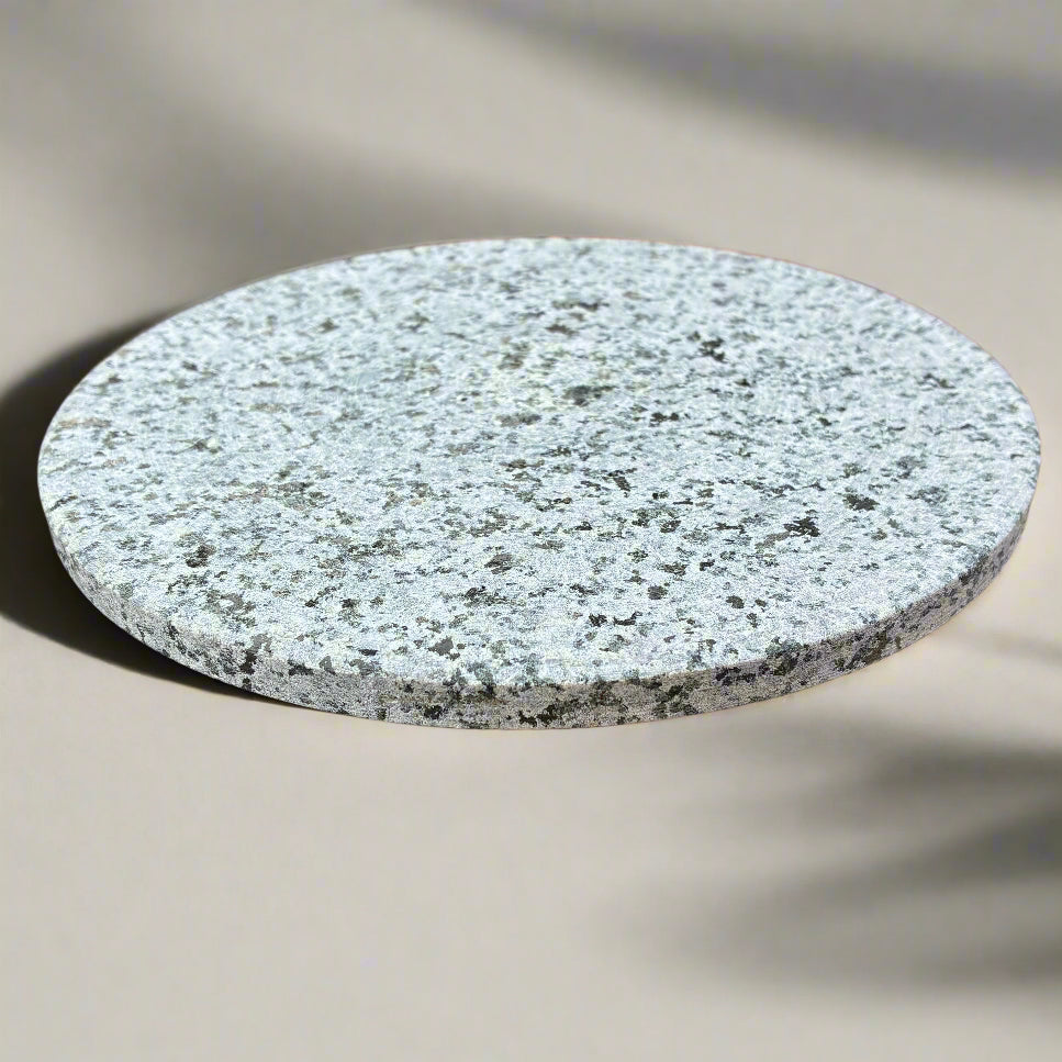 Round stone coaster on a beige surface