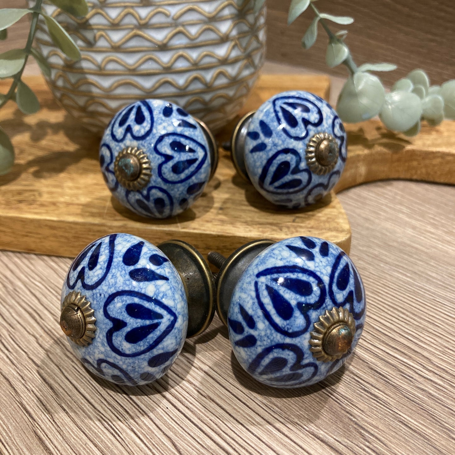 Set of 4 hand painted ceramic knob handles - pointing outwards