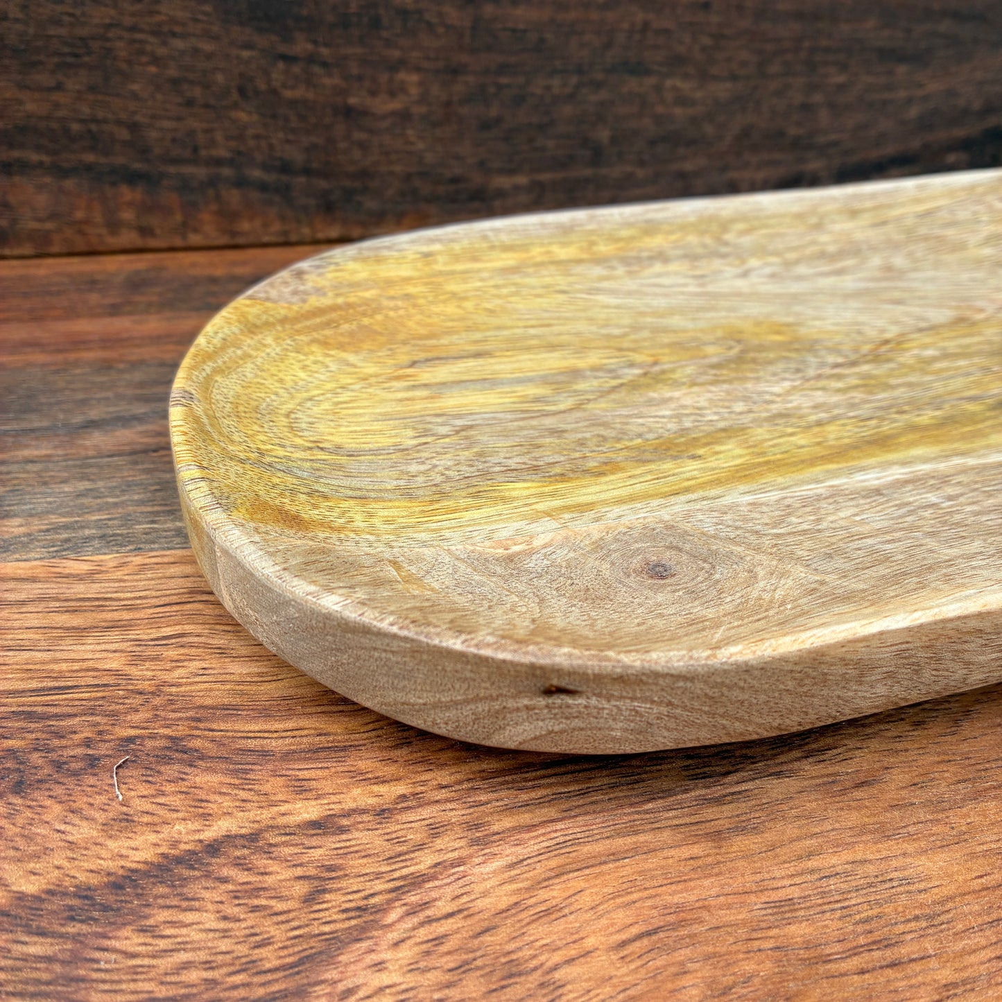 Wooden cutting board on a wooden surface