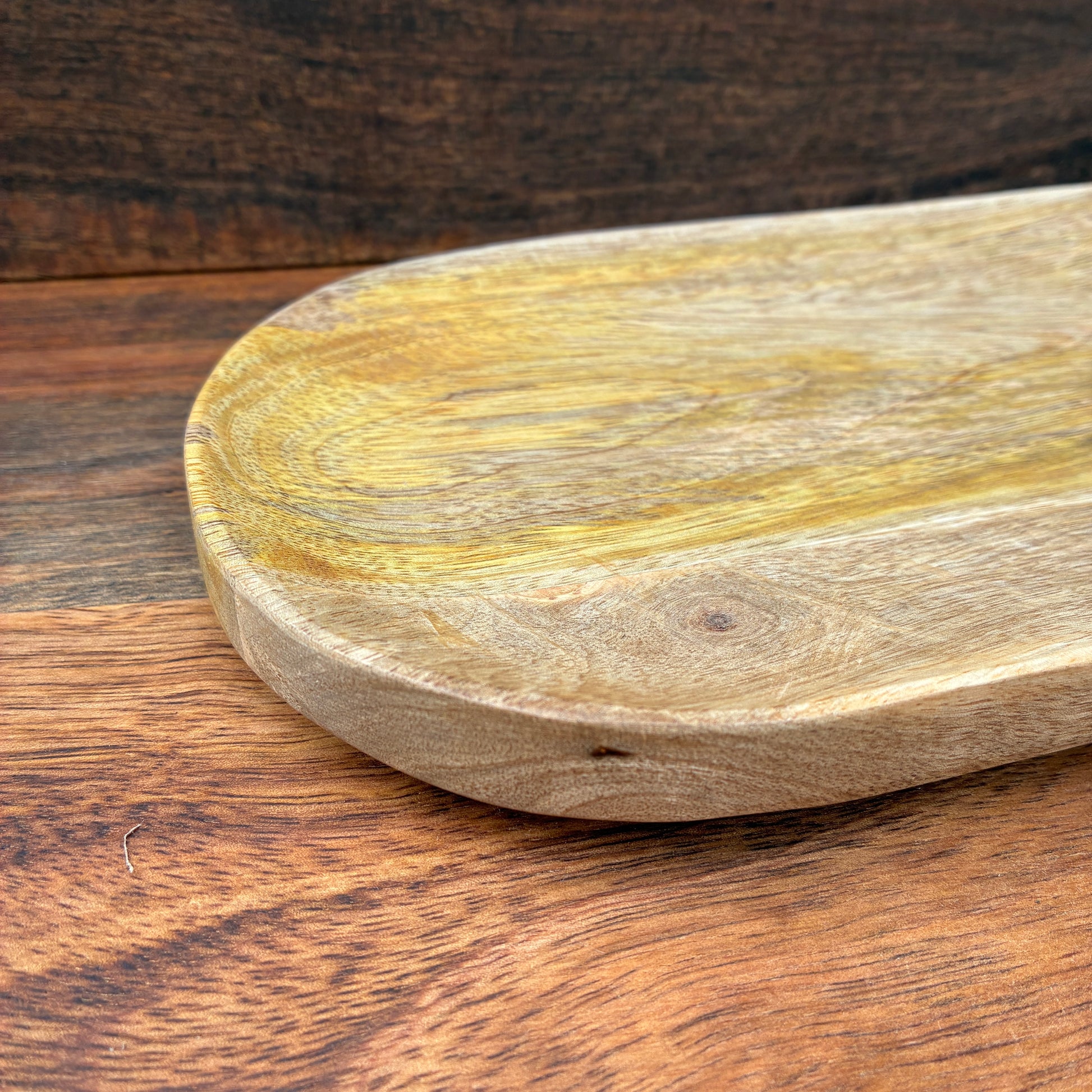 Wooden cutting board on a wooden surface
