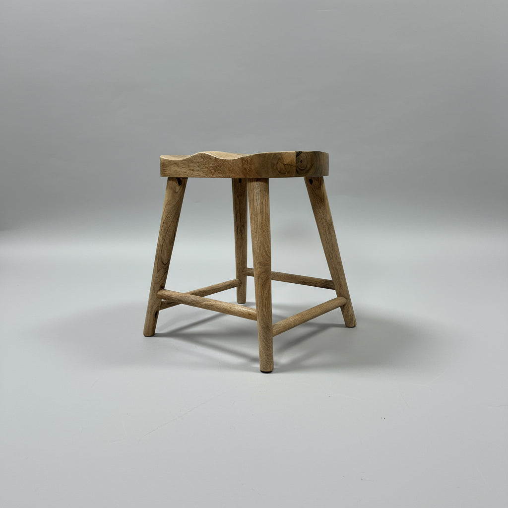 Wooden stool on a wooden floor with a neutral wall background