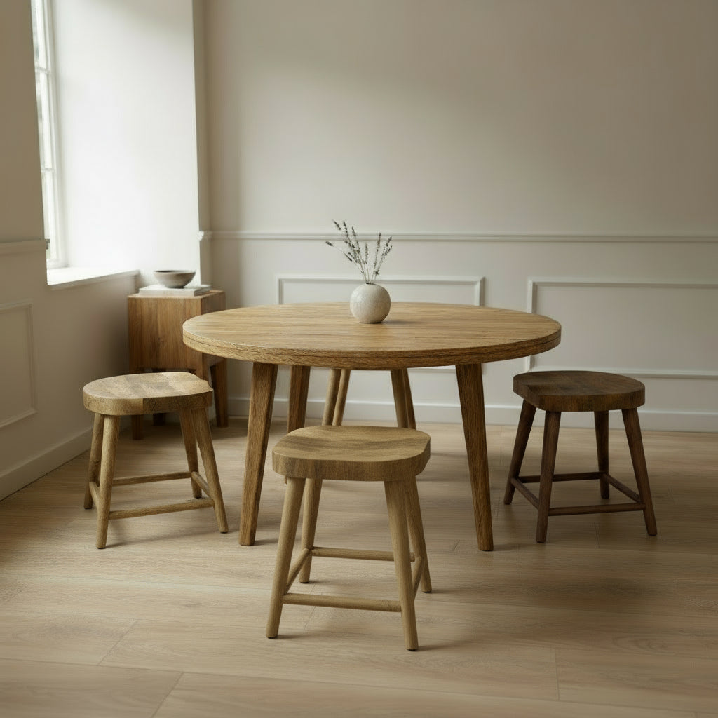 Wooden dining table with four stools in a minimalistic room.