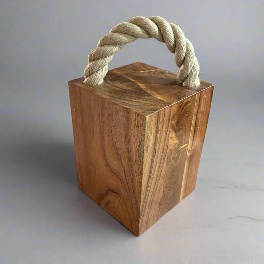 Wooden block with a rope handle on a kitchen counter