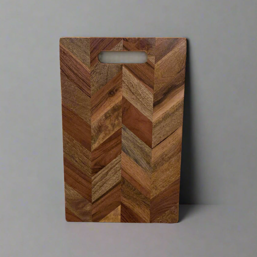 Wooden cutting board with a chevron pattern on a gray background