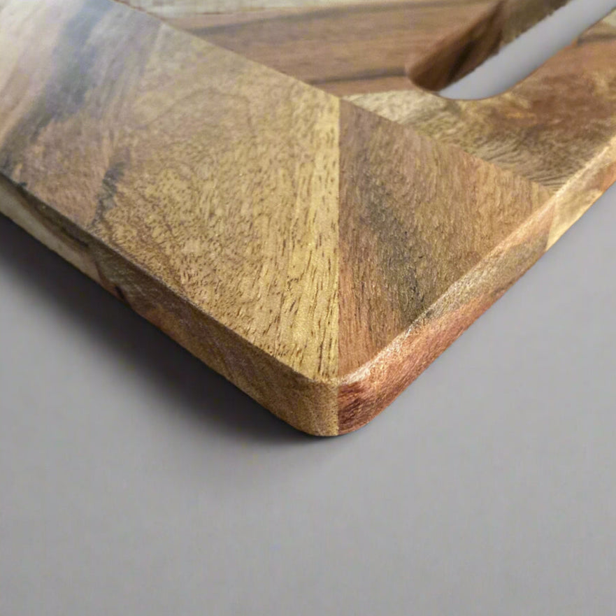 Wooden cutting board on a gray surface