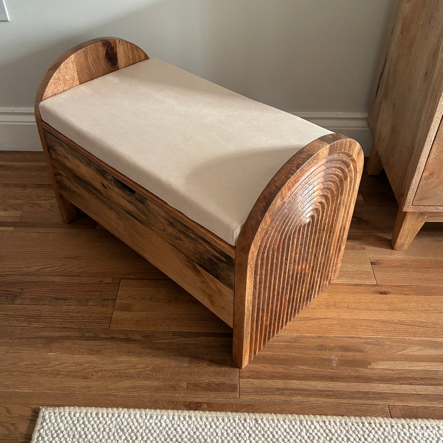 Wooden bench with a cushion on a wooden floor