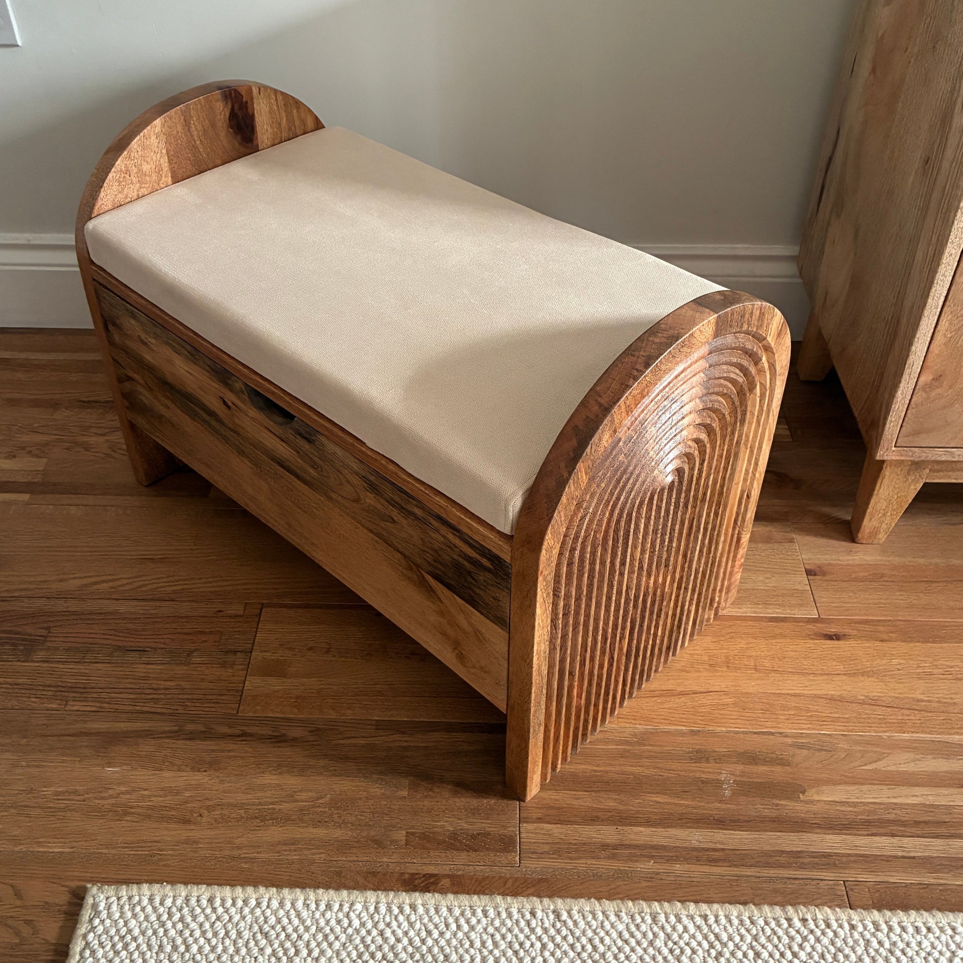 Wooden bench with a cushion on a wooden floor