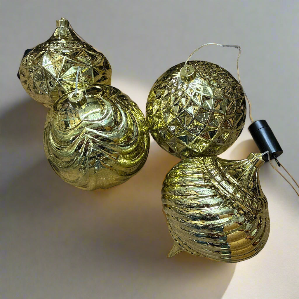 Gold decorative ornaments on a tiled floor with packaging in the background