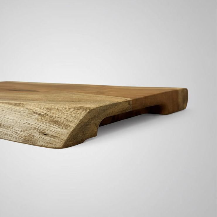 Wooden cutting board on a textured surface with a neutral background