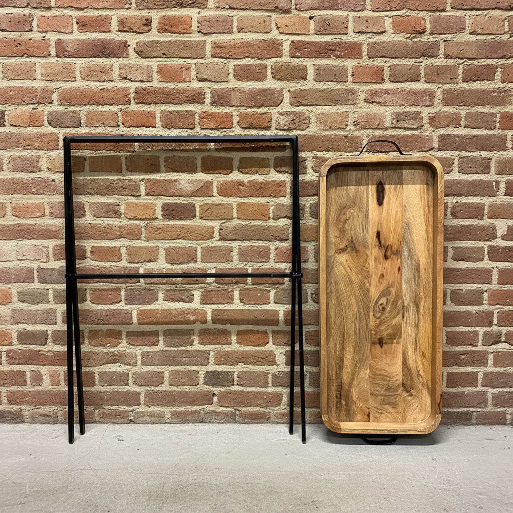 Wooden tray and metal frame against a metallic wall.