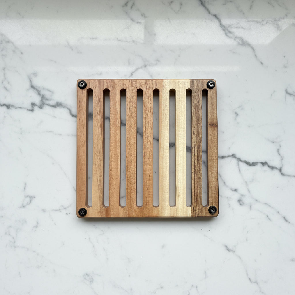 Wooden cutting board with slotted design on a concrete surface