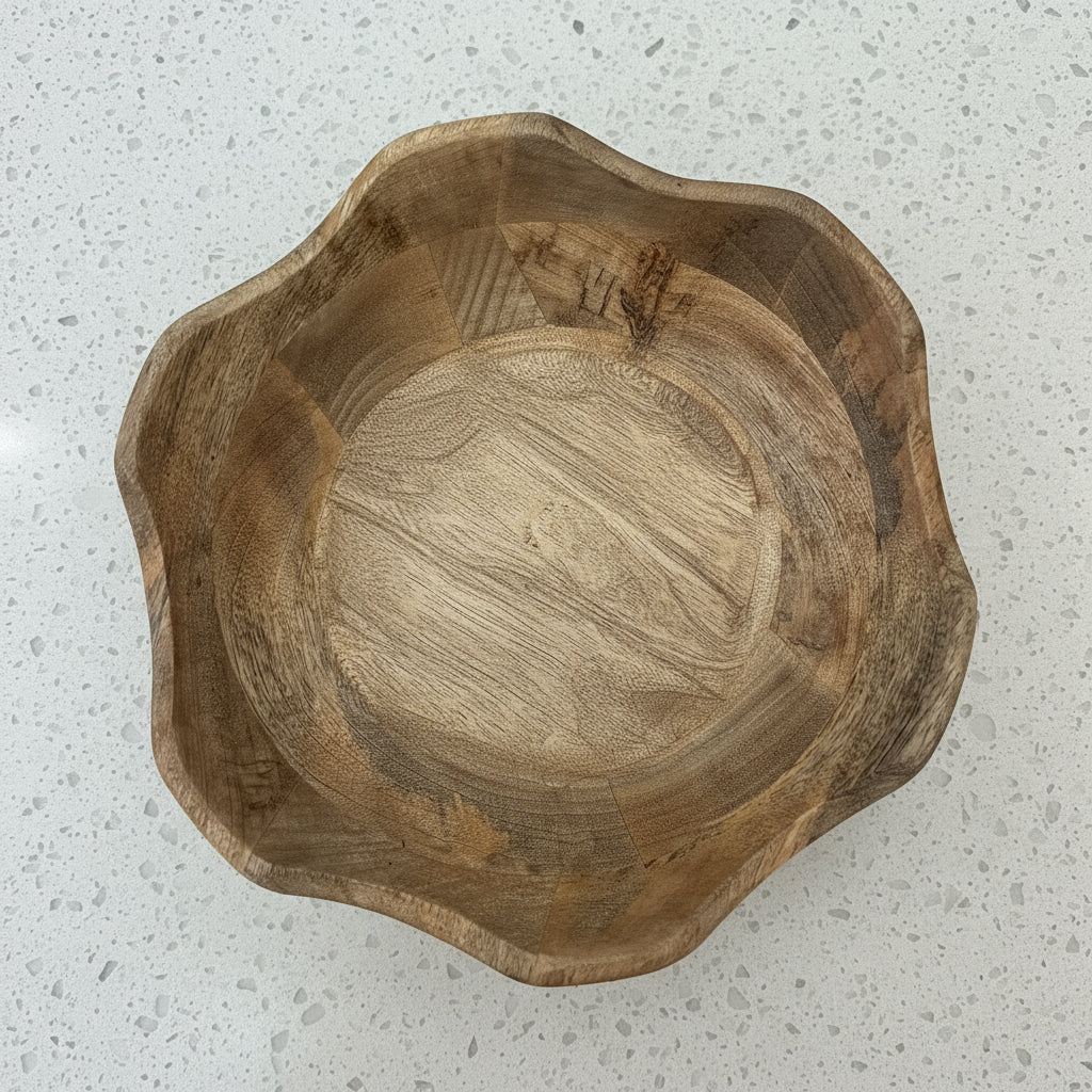 Wooden bowl and spoon on a patterned rug